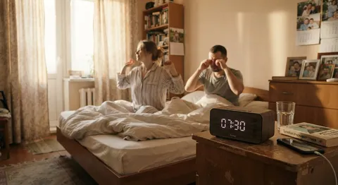 A modern alarm clock on a bedside table showing 07:30, soft morning sun rays shining through curtains, high resolution, cozy bedroom interior. Featuring Slavic / Eastern-European (Russian) people with natural authentic appearance; modern Russian setting and context; realistic, not staged. Do NOT add any text, letters, captions or logos in the image. Avoid American clichés and forced diversity casting.